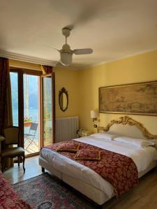 a bedroom with a large bed and a balcony at Hotel San Marino in Laglio