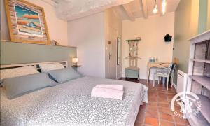 a bedroom with a bed and a table in it at Maison d'hôtes KerCalow, Chambres d'hôtes in Pleine-Fougères