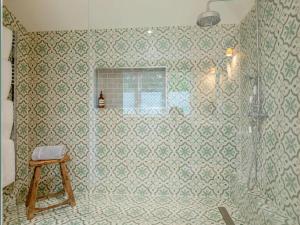 a bathroom with a shower with a stool in it at 1 Bed in Wincanton oc-83499 in Hilton +8 photos