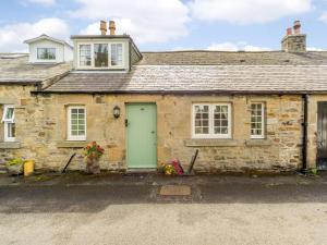 an old stone house with a green door at 1 Bed in Hexham oc-89085 in Bellingham +8 photos