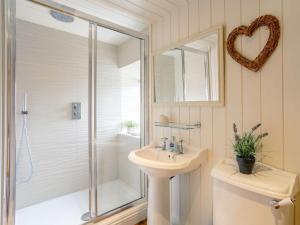 a bathroom with a shower and a sink and a mirror at 3 Bed in Helmsley oc-82891 in Helmsley +16 photos