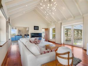 a living room with a white couch and a table at Diamond Cottage in Ballyconneely