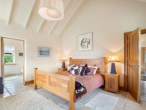 a bedroom with a large bed and two lamps at Diamond Cottage in Ballyconneely