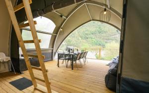 a tent with a table and chairs in it at Lodge Holidays - Camping Gajole in Arsiè