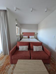 a living room with a couch and a bed at BelMare 327 Aqua in Międzyzdroje