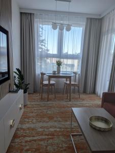 a living room with a table and a couch and a dining room at BelMare 327 Aqua in Międzyzdroje