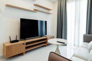 a living room with a flat screen tv on a wall at La Living Collection in Ho Chi Minh City +118 photos