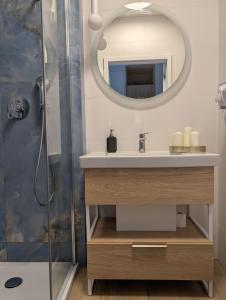 a bathroom with a sink and a shower at BelMare 327 Aqua in Międzyzdroje +5 photos