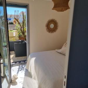 a bedroom with a bed and a door to a patio at On the Beach in Lacanau-Océan +40 photos