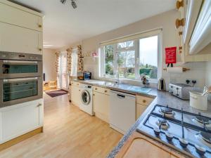 a kitchen with a sink and a dishwasher at 4 Bed in Shanklin oc-ic068 in Shanklin