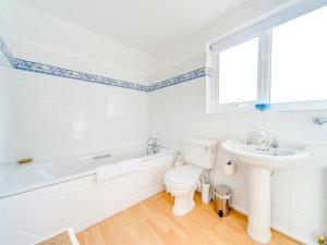 a white bathroom with a toilet and a sink at 4 Bed in Shanklin oc-ic068 in Shanklin +16 photos