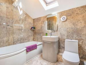 a bathroom with a toilet and a tub and a sink at 3 Bed in Nr Masham oc-g0149 in Healey +25 photos