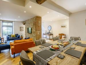 a dining room with a table and a living room at 3 Bed in Skipton oc-84014 in Rylstone