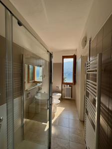 a bathroom with two toilets and a sink at Hotel San Marino in Laglio +67 photos