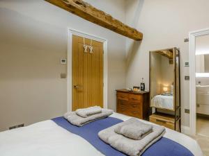 a bedroom with a large bed with towels on it at 3 Bed in Skipton oc-84014 in Rylstone