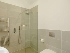 a bathroom with a shower with a toilet and a sink at 3 Bed in Skipton oc-84014 in Rylstone +11 photos