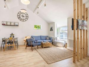a living room with a blue couch and a table at 2 Bed in Lymington oc-87885 in Sway