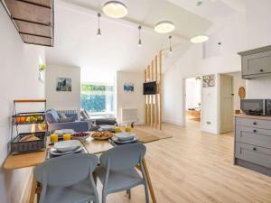 a kitchen and living room with a table and chairs at 2 Bed in Lymington oc-87885 in Sway