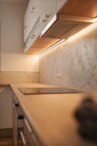 a kitchen with a marble counter top with a light at Haus Auf Bulz - Klippeneck in Denkingen