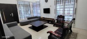 a living room with a couch and a table at D'RailHouse65 in Gemas