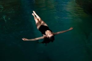 a woman is swimming in the water at Hotel Vierjahreszeiten in Flachau
