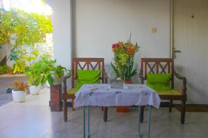 a table and two chairs with a table and some plants at Krautergarten Resort & Wellness in Negombo