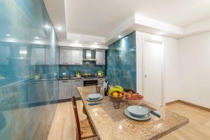 a kitchen with a table with a bowl of fruit on it at Tenuta VillaMar in Cursi
