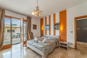 a bedroom with a bed and a balcony at Tenuta VillaMar in Cursi