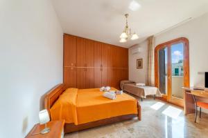 a bedroom with an orange bed and a desk at Tenuta VillaMar in Cursi