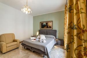 a bedroom with a bed and a chair at Tenuta VillaMar in Cursi +57 photos