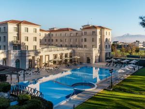 a view of a building with a swimming pool at Grecotel Larissa Imperial in Larisa