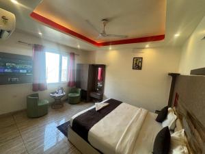a bedroom with a bed in a room with a ceiling at V Hotel Dev Residency Airport Pick up complimentary in New Delhi