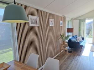 a living room with a blue couch and a chair at Bungalow 024 in Petten