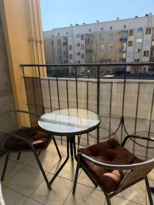 a table and chairs on a balcony with a view at Apartments Chaiky Kyiv in Chayky