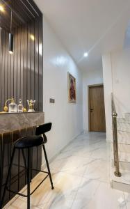 a kitchen with a counter and a stool in a room at Le ChriShol in Ikuata