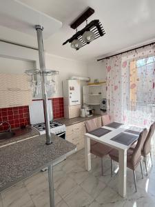 a kitchen with a table and a dining room at Apartments Chaiky Kyiv in Chayky