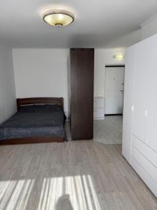 a bedroom with a bed and a closet at Apartments Chaiky Kyiv in Chayky