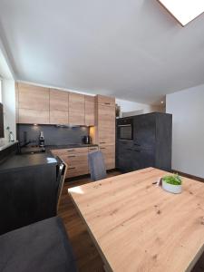 a kitchen with a wooden table in a kitchen at Apart Bader in Ehrwald