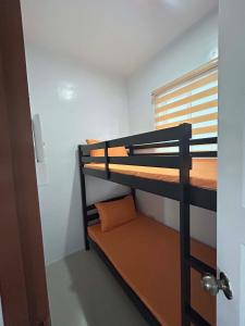 a room with two bunk beds and a window at J20 Building Rental in Calatagan