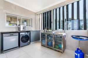 a laundry room with a washer and dryer at Sea View Luxury Penthouse in Ballito