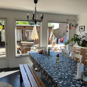 a dining room with a table with a blue table cloth at Workers Stay - Construction Worker Housing Sweden in Lund