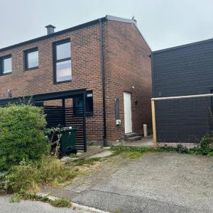 a brick building with a door and a garage at Workers Stay - Construction Worker Housing Sweden in Lund