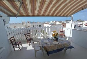 a table and chairs on a balcony with a view at Residence Poseidon in Lido Marini