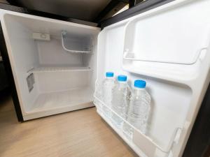 an open refrigerator with bottles of water in it at Ekonomy Hotel Myeongdong Premier in Seoul