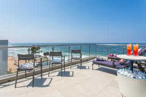 a balcony with chairs and a view of the beach at Sea View Luxury Penthouse in Ballito