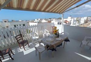a table and chairs on a balcony with a view at Residence Poseidon in Lido Marini