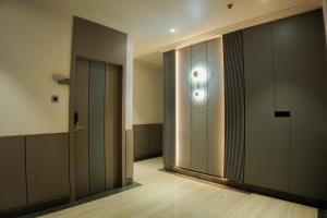 a hallway with two elevators and a glass door at DHANUSH STAYS - A Boutique Accommodation in Varanasi