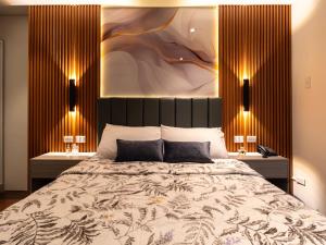 a bedroom with a large bed and two night stands at Relaxing 1-Bedroom Resort Condo Unit at Tambuli Seaside Living, Mactan, Lapu-lapu City in Maribago +19 photos