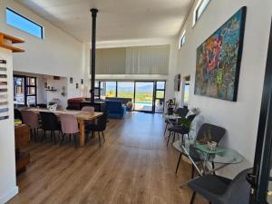 a living room with a table and chairs at Walkerbay Dunes Lodge in Stanford