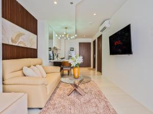 a living room with a couch and a table at Relaxing 1-Bedroom Resort Condo Unit at Tambuli Seaside Living, Mactan, Lapu-lapu City in Maribago